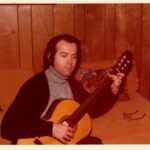 Robert Guthrie (practicing guitar at home)